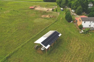 Earth Right Mid-Atlantic solar panels installed on shed for the home in the background
