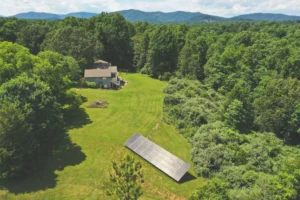Earth Right Mid-Atlantic ground mounted solar panels with home in the background