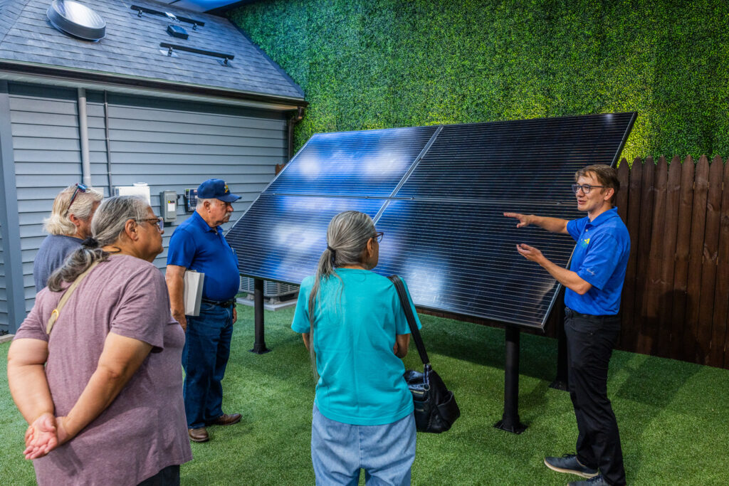 energy consultant educates homeowners on solar ground mount in educational showroom